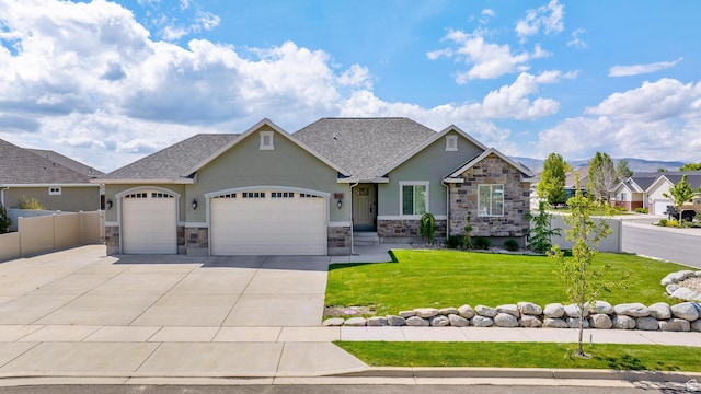 craftsman-style house featuring an attached garage, a front lawn, stone siding, stucco siding, and concrete driveway