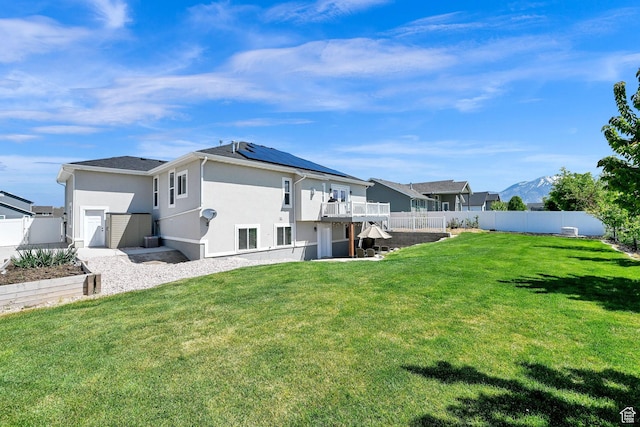 2515 W 3375 S, West Haven, UT 84401 - rear view of house with a lawn, a fenced backyard, stucco siding, and a deck
