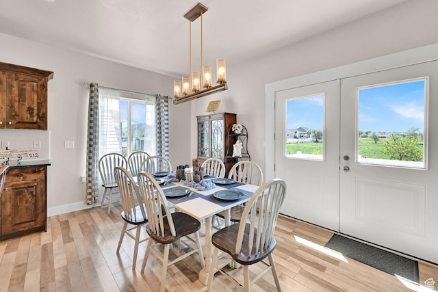 2515 W 3375 S, West Haven, UT 84401 - dining area with french doors, light wood-type flooring, and a notable chandelier