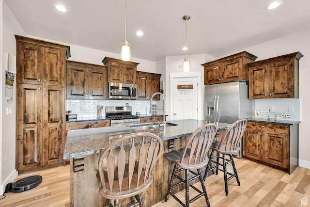2515 W 3375 S, West Haven, UT 84401 - kitchen featuring stainless steel appliances, a sink, light wood-style flooring, and tasteful backsplash