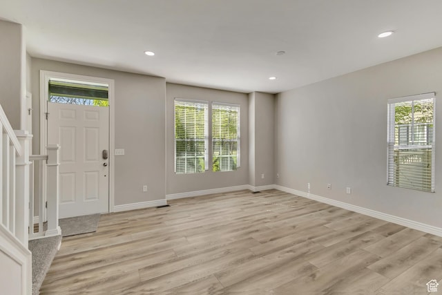 foyer with recessed lighting, light wood finished floors, and baseboards