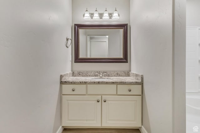 bathroom featuring baseboards and vanity