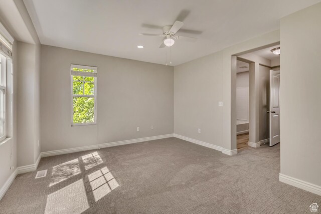 carpeted empty room with a ceiling fan, baseboards, visible vents, and recessed lighting
