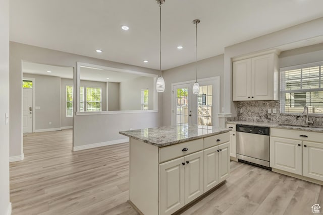 kitchen featuring a sink, light wood-style floors, backsplash, recessed lighting, and stainless steel dishwasher