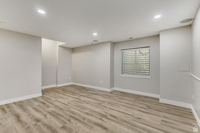 below grade area with baseboards, recessed lighting, and light wood-type flooring