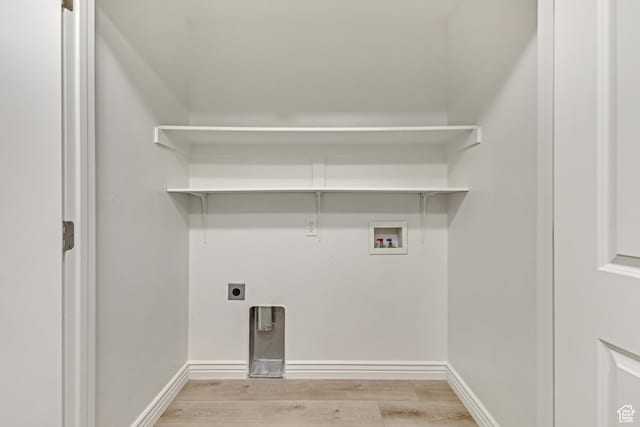 laundry area with washer hookup, laundry area, electric dryer hookup, baseboards, and light wood-style flooring
