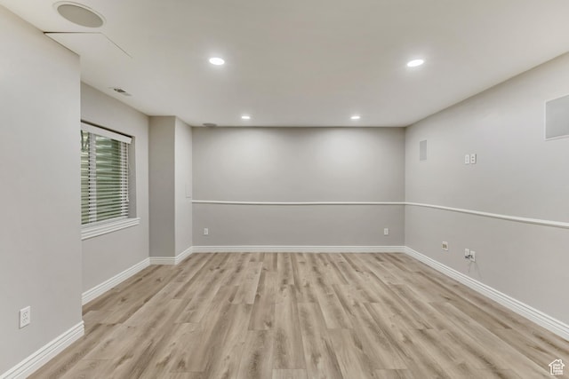 empty room featuring recessed lighting, light wood-style flooring, and baseboards
