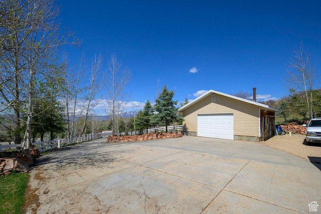 4851 E Lake Creek Rd, Heber City, UT 84032 - view of side of home with a detached garage, fence, and concrete driveway
