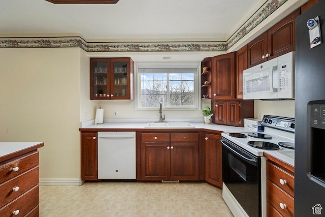 4851 E Lake Creek Rd, Heber City, UT 84032 - kitchen featuring a sink, light countertops, white appliances, and glass insert cabinets