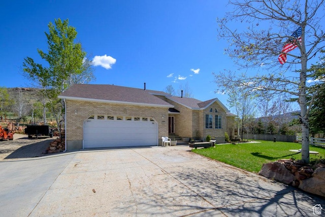 4851 E Lake Creek Rd, Heber City, UT 84032 - ranch-style house with a garage, brick siding, fence, a front lawn, and concrete driveway
