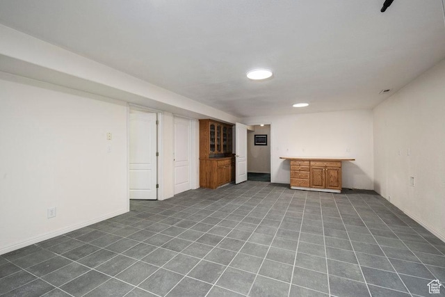 4851 E Lake Creek Rd, Heber City, UT 84032 - finished basement with dark tile patterned flooring, baseboards, and indoor bar