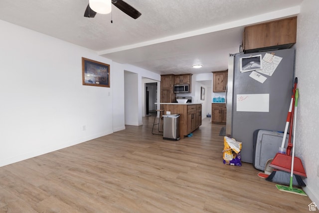 463 E Main St, Salina, UT 84654 - interior space with a breakfast bar, light wood-style floors, a center island, light countertops, and stainless steel appliances