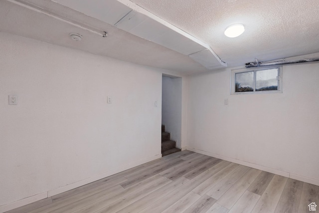 463 E Main St, Salina, UT 84654 - below grade area with stairs, a textured ceiling, baseboards, and light wood-type flooring
