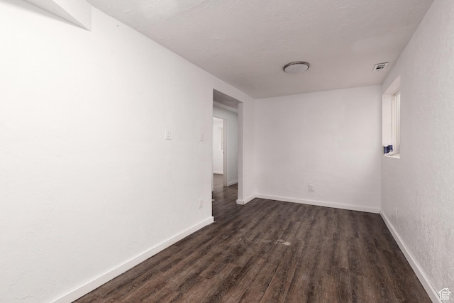 463 E Main St, Salina, UT 84654 - unfurnished room featuring baseboards, dark wood finished floors, and visible vents