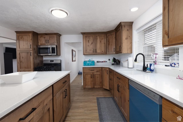 463 E Main St, Salina, UT 84654 - kitchen featuring dishwasher, light countertops, light wood-style flooring, stainless steel microwave, and gas range oven