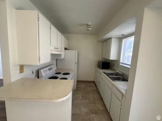 558 N Redwood Rd Unit 2-4, Salt Lake City, UT 84116 - kitchen with electric range, a peninsula, light countertops, under cabinet range hood, and a sink