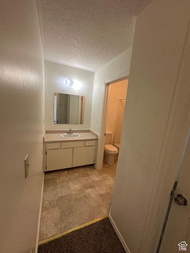 558 N Redwood Rd Unit 2-4, Salt Lake City, UT 84116 - bathroom featuring toilet, a textured ceiling, and vanity