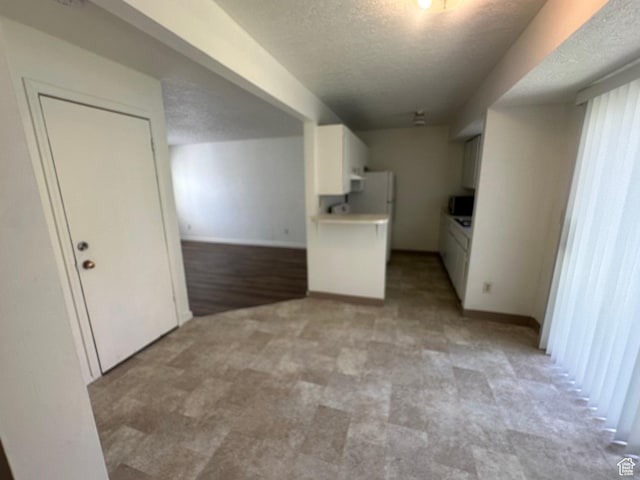 558 N Redwood Rd Unit 2-4, Salt Lake City, UT 84116 - interior space with baseboards, a textured ceiling, and light carpet