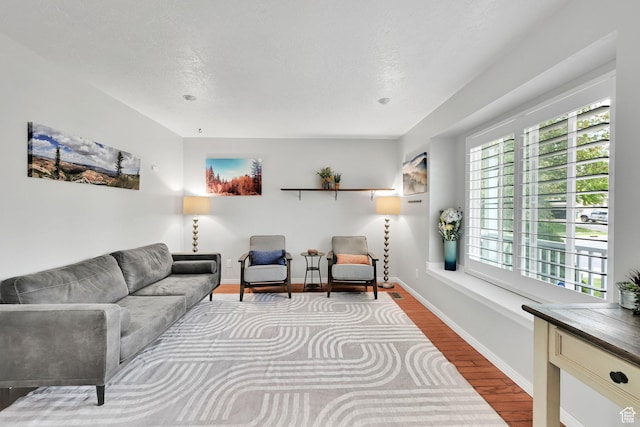 267 W 1600 N, Layton, UT 84041 - living room featuring a healthy amount of sunlight, baseboards, and wood finished floors