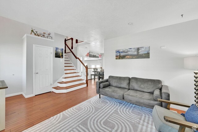 267 W 1600 N, Layton, UT 84041 - living room with baseboards, wood finished floors, and stairway