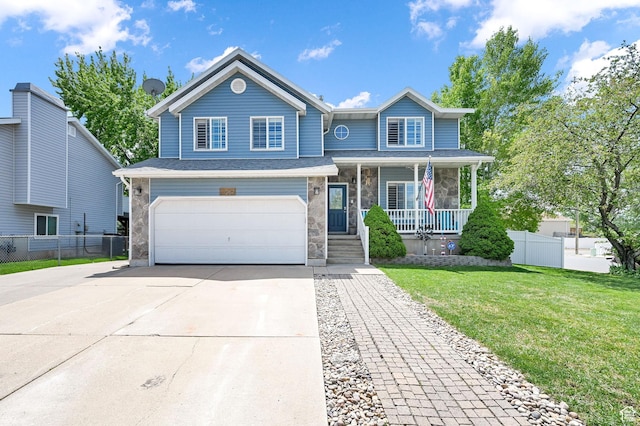 view of front of house featuring covered porch, driveway, a front yard, fence, and an attached garage