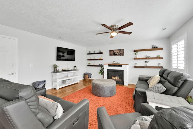 267 W 1600 N, Layton, UT 84041 - living area with a textured ceiling, ceiling fan, a lit fireplace, and wood finished floors