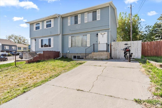 view of front of house with fence and a front yard