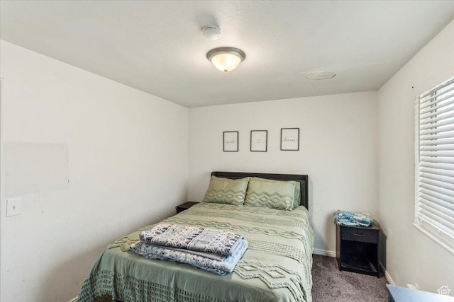 bedroom with carpet floors and baseboards