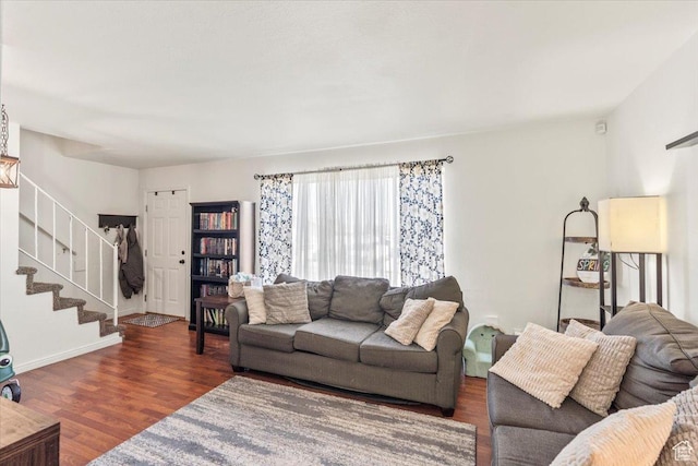 living room with stairs and wood finished floors