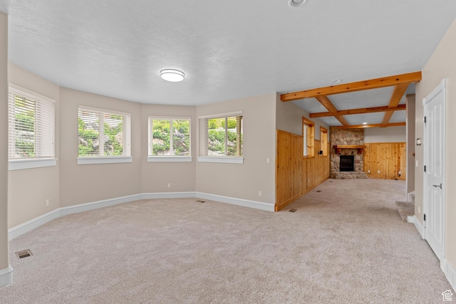 359 E 680 N, Lindon, UT 84042 - unfurnished living room with wood walls, healthy amount of natural light, a fireplace, and carpet floors