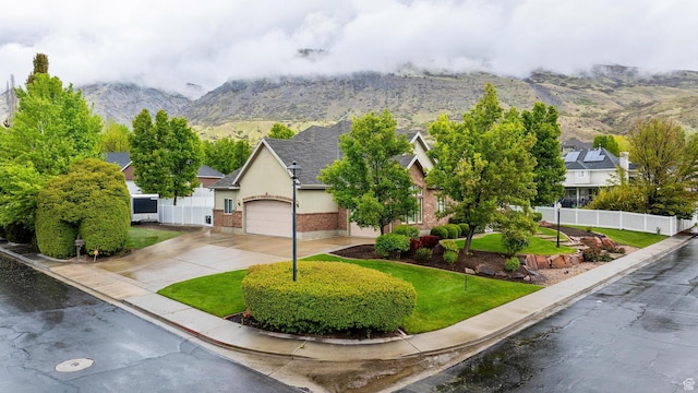 359 E 680 N, Lindon, UT 84042 - view of front of house featuring driveway, a mountain view, brick siding, an attached garage, and stucco siding