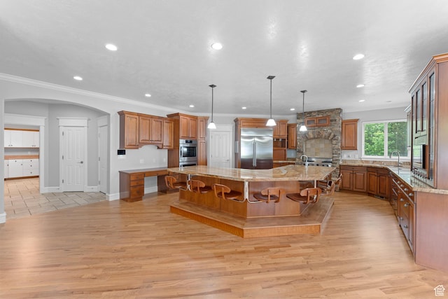 359 E 680 N, Lindon, UT 84042 - kitchen with stainless steel appliances, brown cabinets, a large island with sink, light wood finished floors, and recessed lighting