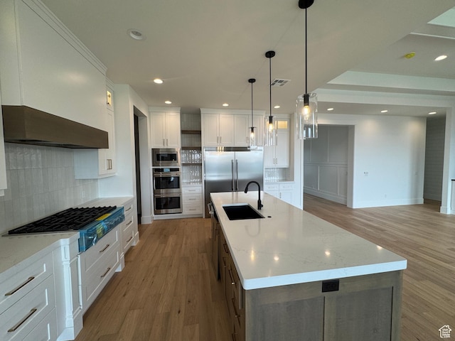 5269 W 2040 S, Hurricane, UT 84737 - kitchen with built in appliances, white cabinets, a sink, light wood-style flooring, and backsplash