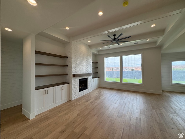 5269 W 2040 S, Hurricane, UT 84737 - unfurnished living room with baseboards, light wood finished floors, ceiling fan, and a large fireplace