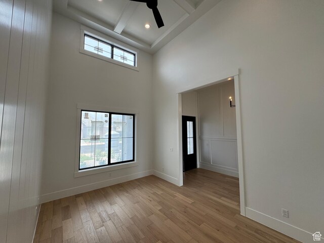5269 W 2040 S, Hurricane, UT 84737 - unfurnished room featuring baseboards, light wood-style flooring, a towering ceiling, and beamed ceiling
