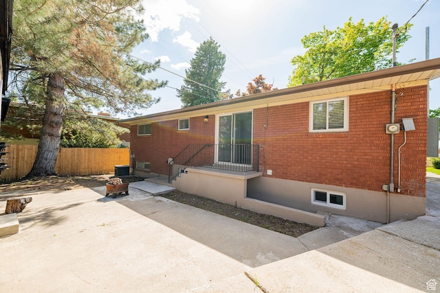 4432 Orchard Ave, South Ogden, UT 84403 - rear view of house featuring a patio, fence, and brick siding