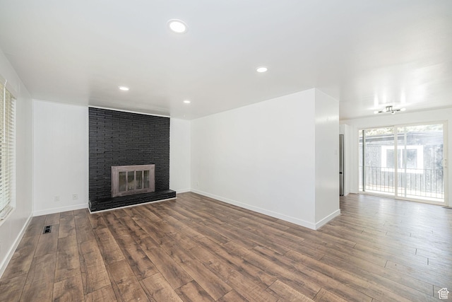 4432 Orchard Ave, South Ogden, UT 84403 - unfurnished living room featuring baseboards, recessed lighting, a brick fireplace, and wood finished floors