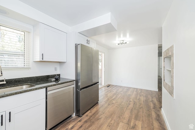 4432 Orchard Ave, South Ogden, UT 84403 - kitchen featuring white cabinetry, appliances with stainless steel finishes, a sink, and hardwood / wood-style flooring