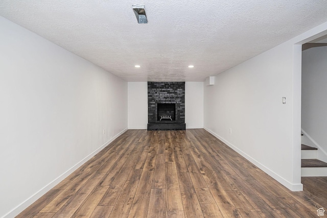 4432 Orchard Ave, South Ogden, UT 84403 - unfurnished living room featuring wood finished floors, a fireplace, baseboards, recessed lighting, and a textured ceiling