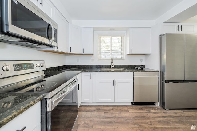 4432 Orchard Ave, South Ogden, UT 84403 - kitchen featuring dark stone counters, white cabinets, a sink, dark wood finished floors, and stainless steel appliances