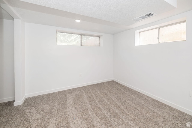 4432 Orchard Ave, South Ogden, UT 84403 - below grade area with visible vents, a textured ceiling, carpet floors, and baseboards