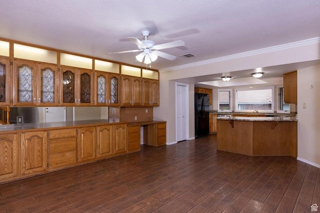 623 E 160 S, St George, UT 84770 - kitchen with freestanding refrigerator, a peninsula, glass insert cabinets, a kitchen bar, and brown cabinets