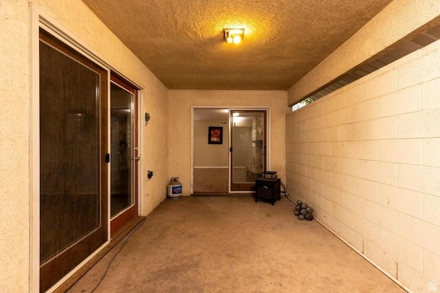623 E 160 S, St George, UT 84770 - interior space featuring unfinished concrete floors, concrete block wall, and a textured ceiling