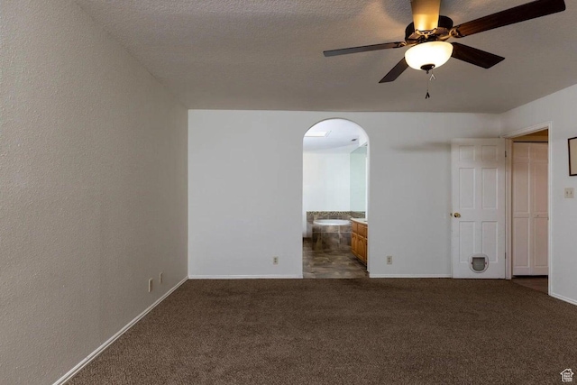 623 E 160 S, St George, UT 84770 - unfurnished room with baseboards, arched walkways, ceiling fan, and dark carpet