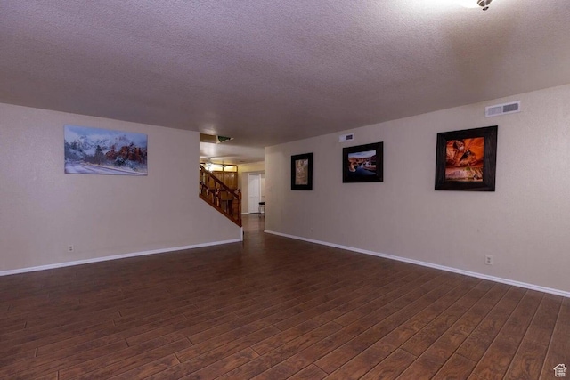 623 E 160 S, St George, UT 84770 - spare room featuring baseboards, dark wood-style flooring, a textured ceiling, and visible vents