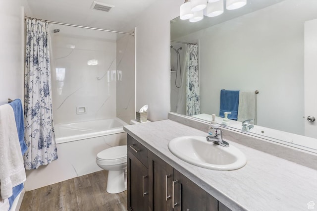 1150 W 200 S, Logan, UT 84321 - full bath with visible vents, wood finished floors, vanity, toilet, and shower / bath combo with shower curtain