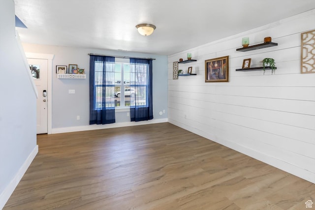 1150 W 200 S, Logan, UT 84321 - unfurnished dining area featuring wooden walls, baseboards, and wood finished floors