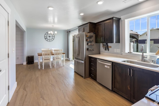 1150 W 200 S, Logan, UT 84321 - kitchen with dark brown cabinets, a sink, light countertops, an inviting chandelier, and stainless steel appliances