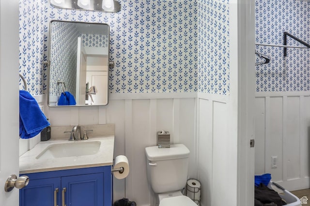 1150 W 200 S, Logan, UT 84321 - bathroom with vanity, a wainscoted wall, a decorative wall, and toilet