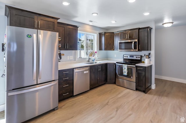 1150 W 200 S, Logan, UT 84321 - kitchen with light countertops, appliances with stainless steel finishes, a sink, and light wood-style floors